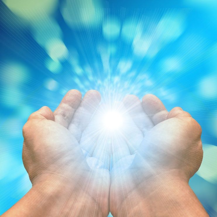 Reiki Energy in Hands, Hands together with glowing light