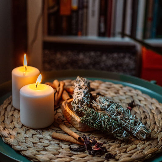 Candles for manifestation arranged with herbs and tools for a ceremony
