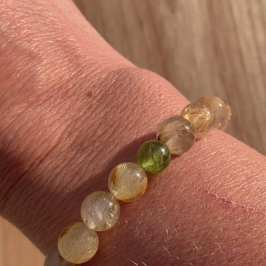Video of Healing Crystal Bracelets Rutilated Quartz with Peridot Accent in the Sun