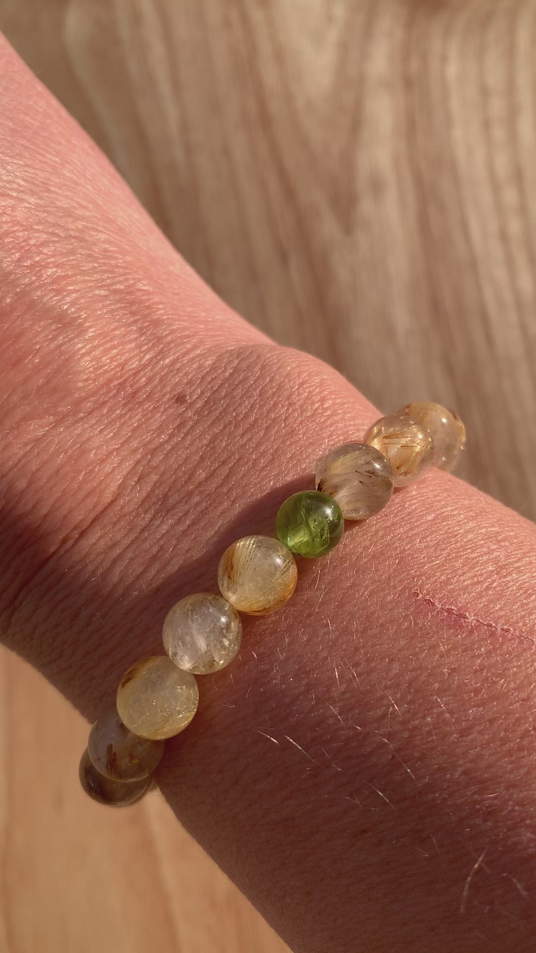 Video of Healing Crystal Bracelets Rutilated Quartz with Peridot Accent in the Sun